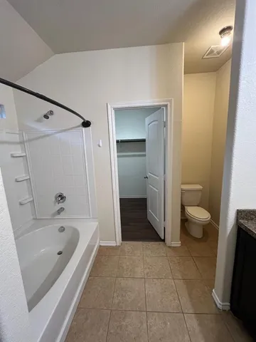a bathroom with a bathtub sink and toilet