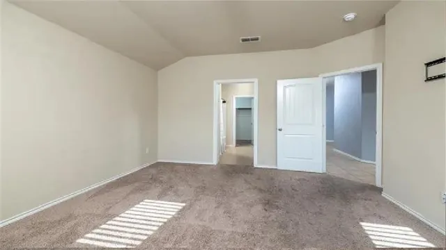 an empty room with windows and closet