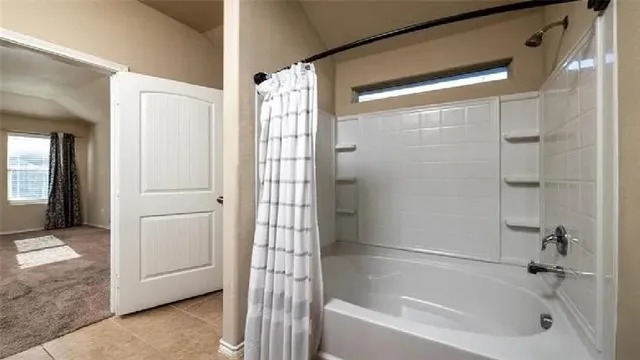 a bathroom with a bathtub and a shower