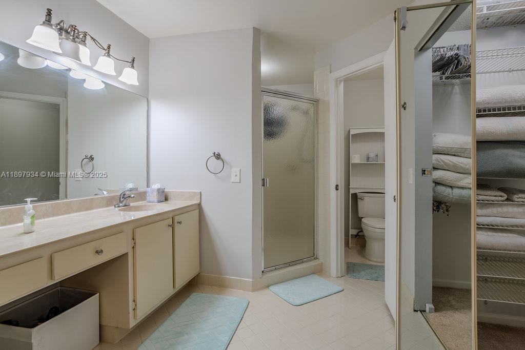 6500 Via Regina, Unit 8 Boca Raton, FL 33433 - Photo 13 of 31 a bathroom with a double vanity sink mirror and shower