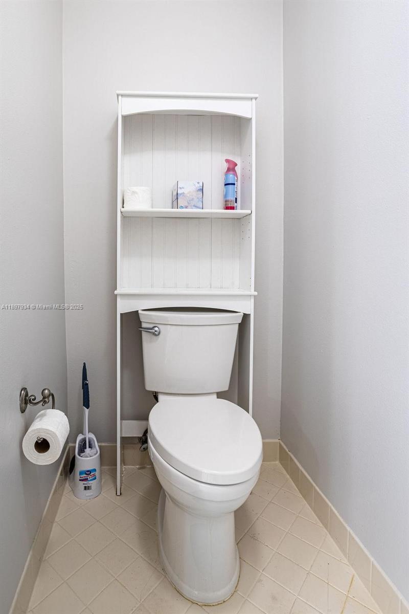 6500 Via Regina, Unit 8 Boca Raton, FL 33433 - Photo 14 of 31 a white toilet sitting next to a bathroom sink
