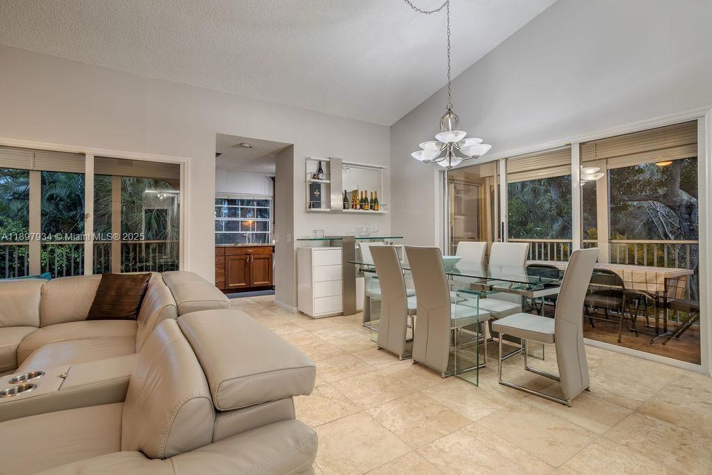 6500 Via Regina, Unit 8 Boca Raton, FL 33433 - Photo 2 of 31 a living room with furniture and a chandelier