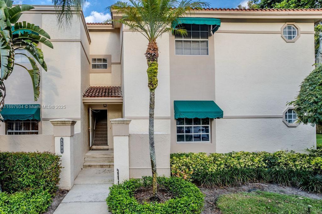 6500 Via Regina, Unit 8 Boca Raton, FL 33433 - Photo 28 of 31 a view of a house with a yard and plants