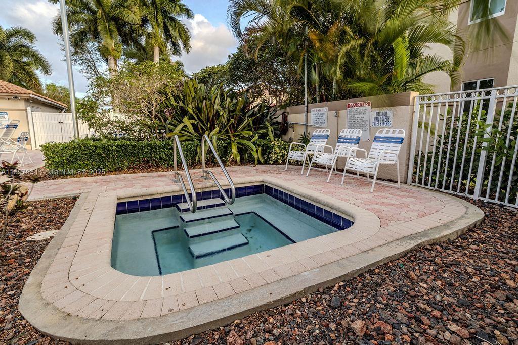6500 Via Regina, Unit 8 Boca Raton, FL 33433 - Photo 30 of 31 a view of a swimming pool with a patio
