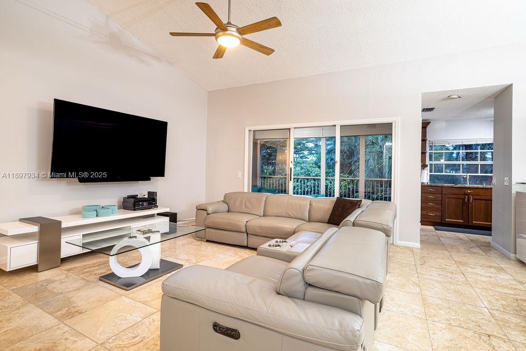 6500 Via Regina, Unit 8 Boca Raton, FL 33433 - Photo 3 of 31 a living room with furniture and a flat screen tv