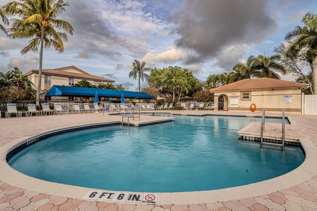 6500 Via Regina, Unit 8 Boca Raton, FL 33433 - Photo 31 of 31 a swimming pool with outdoor seating and yard