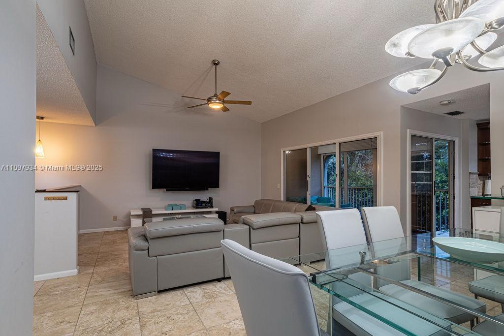 6500 Via Regina, Unit 8 Boca Raton, FL 33433 - Photo 4 of 31 a living room with furniture and a flat screen tv