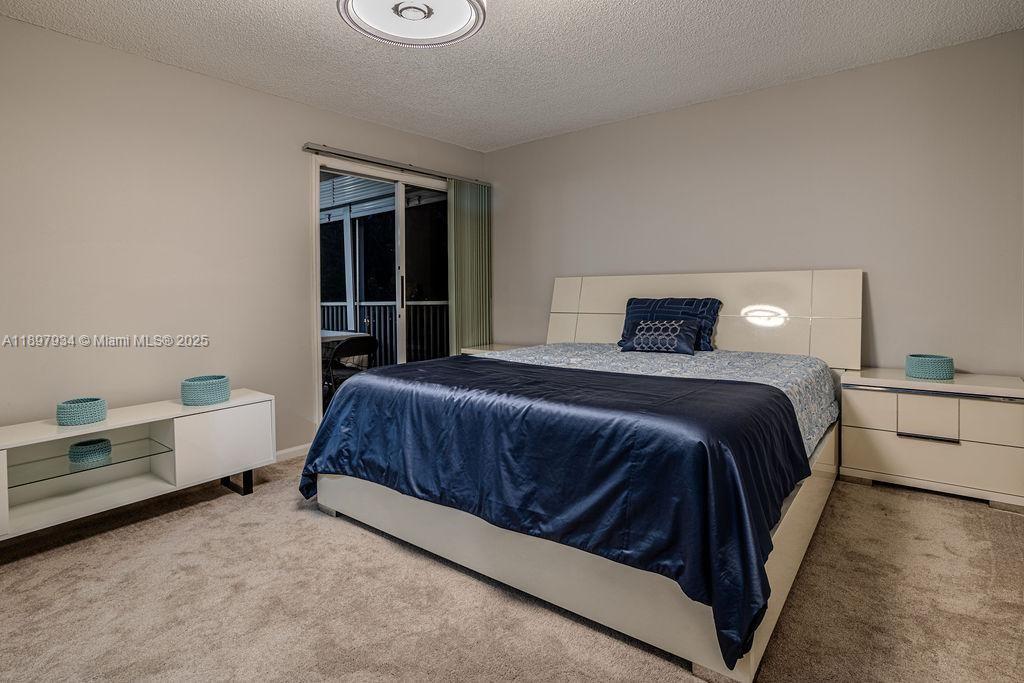 6500 Via Regina, Unit 8 Boca Raton, FL 33433 - Photo 10 of 31 a bedroom with a bed and a dresser