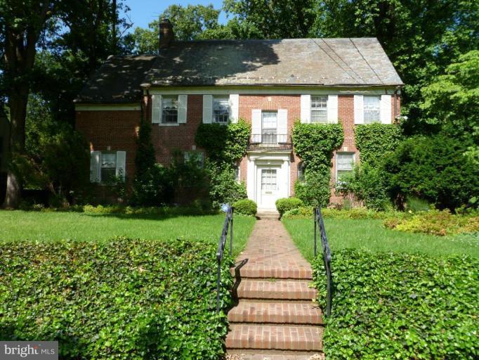 3070 Foxhall Road Northwest Washington, DC 20016 - Photo 1 of 1 a front view of a house with a yard and trees