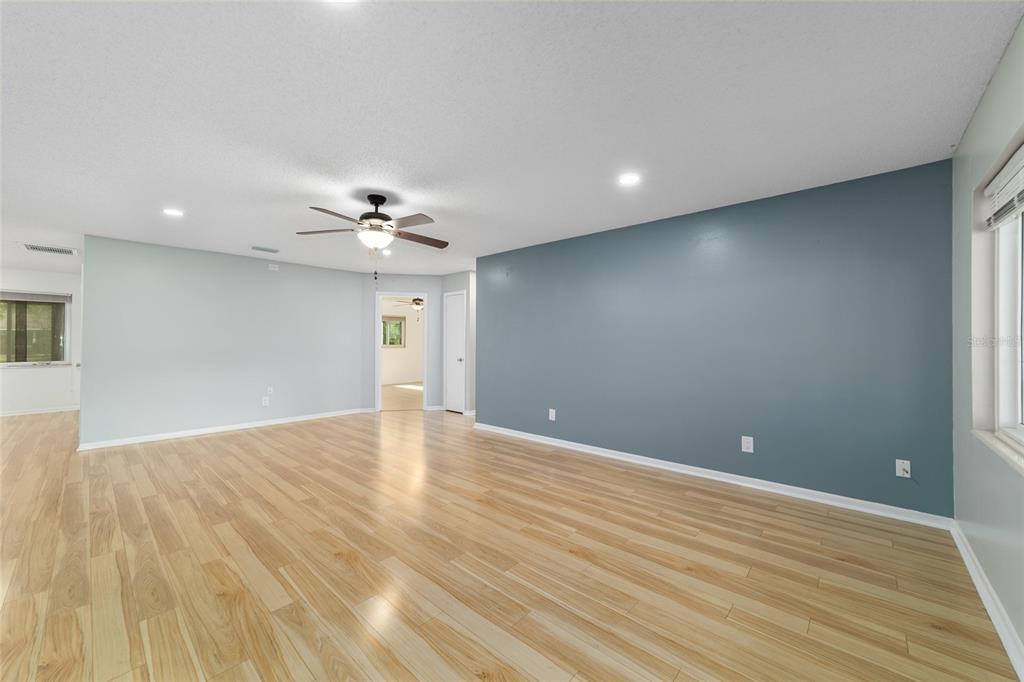 8877 Southwest 96th Street, Unit D Ocala, FL 34481 - Photo 12 of 51 a view of an empty room with wooden floor