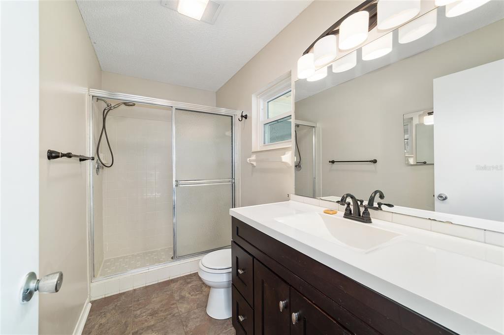 8877 Southwest 96th Street, Unit D Ocala, FL 34481 - Photo 33 of 51 a bathroom with a sink a toilet and shower