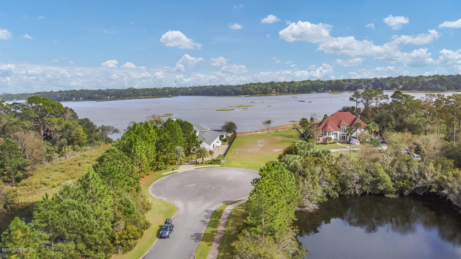 96278 Captains Pointe Road Yulee, FL 32097 - Photo 14 of 17 a view of a lake with table and chairs