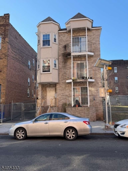 91 Spruce Street Newark, NJ 07102 - Photo 1 of 34 a front view of a house with parking space