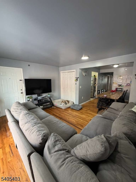 91 Spruce Street Newark, NJ 07102 - Photo 12 of 34 a bedroom with furniture and a flat screen tv