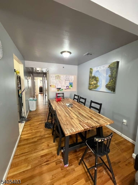 91 Spruce Street Newark, NJ 07102 - Photo 14 of 34 a dining room with a wooden table and chairs