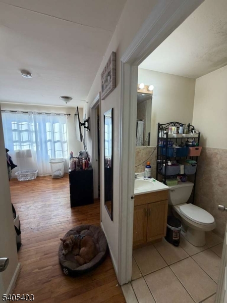 91 Spruce Street Newark, NJ 07102 - Photo 25 of 34 a bathroom with a toilet a sink and a mirror