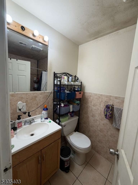 91 Spruce Street Newark, NJ 07102 - Photo 26 of 34 a bathroom with a sink a toilet and a mirror