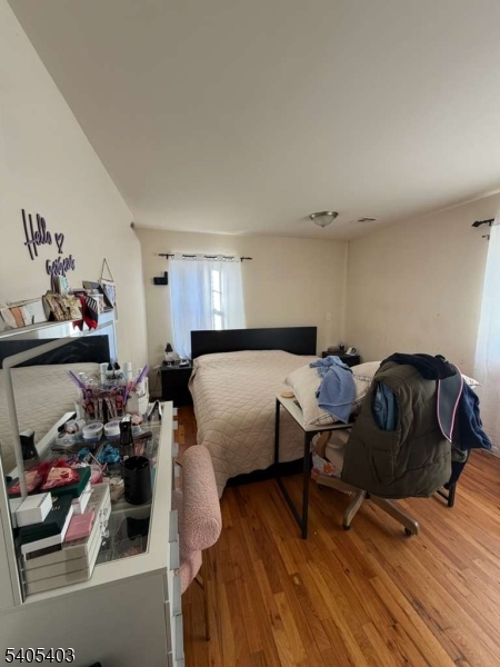 91 Spruce Street Newark, NJ 07102 - Photo 28 of 34 a bedroom with furniture and a wooden floor