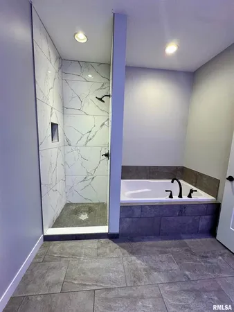 a bathroom with a bathtub and shower