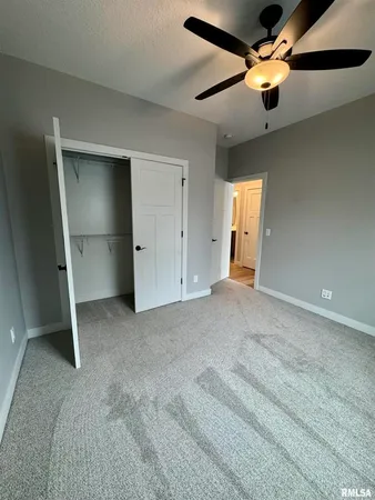 a view of empty room with ceiling fan