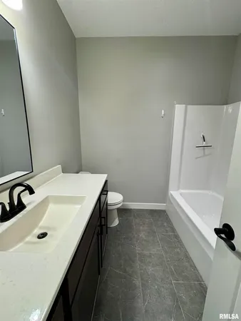 a bathroom with a sink a toilet and tub