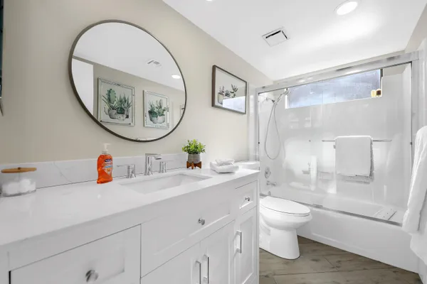 a bathroom with a toilet a sink and a mirror