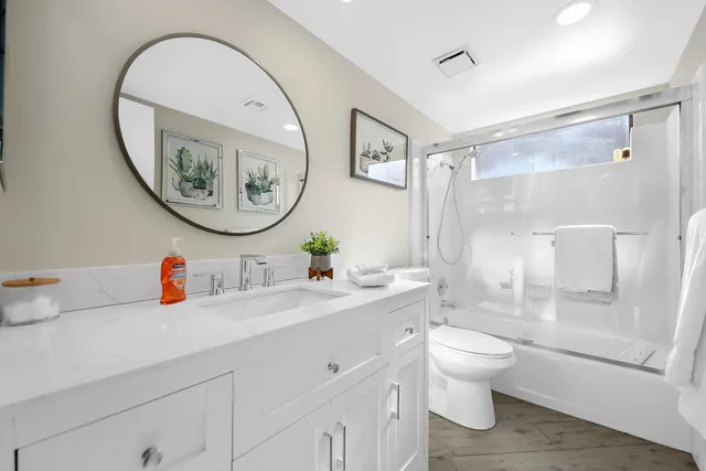 a bathroom with a toilet a sink and a mirror