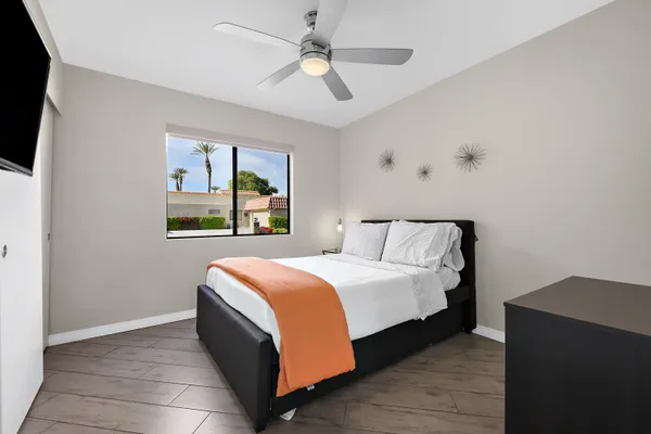 a bedroom with a bed and a window
