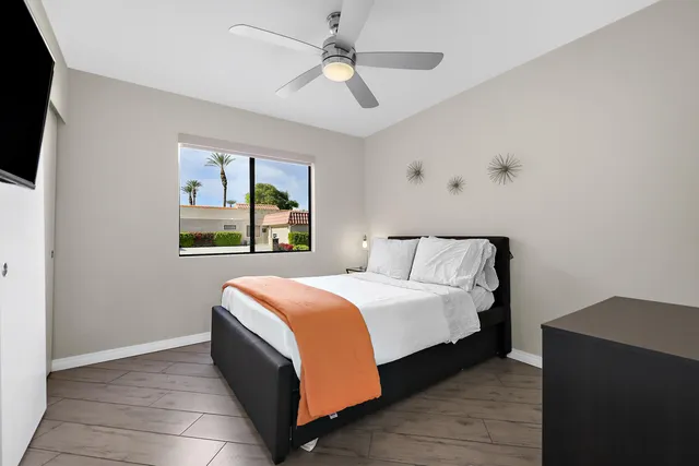 a bedroom with a bed and a window