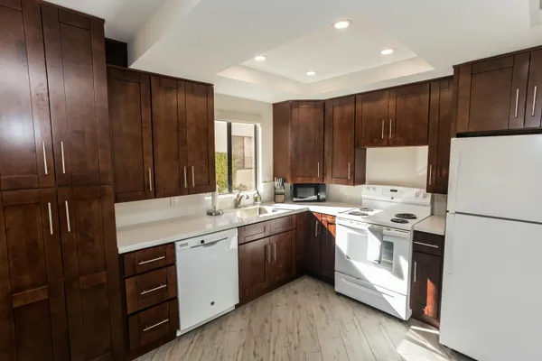 a kitchen with a sink appliances and cabinets