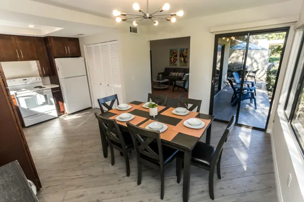 a view of a dining room with furniture and wooden floor