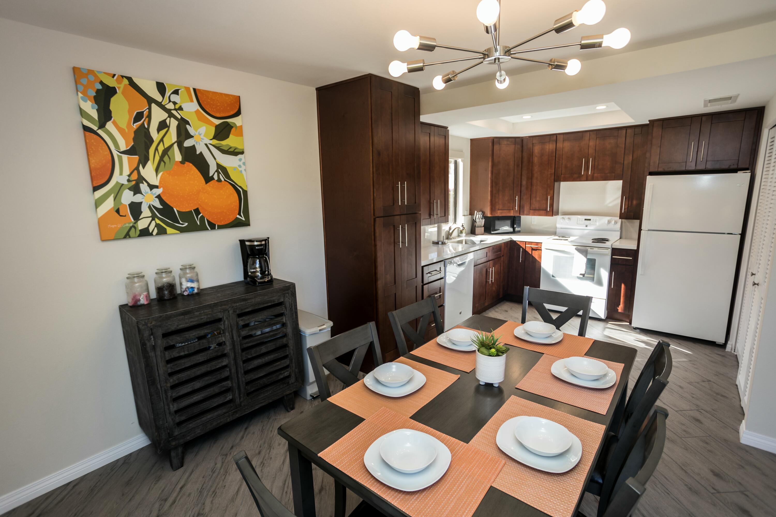 41542 Jupiter Hills Court Palm Desert, CA 92211 - Photo 20 of 29 a view of a dining room with furniture and wooden floor
