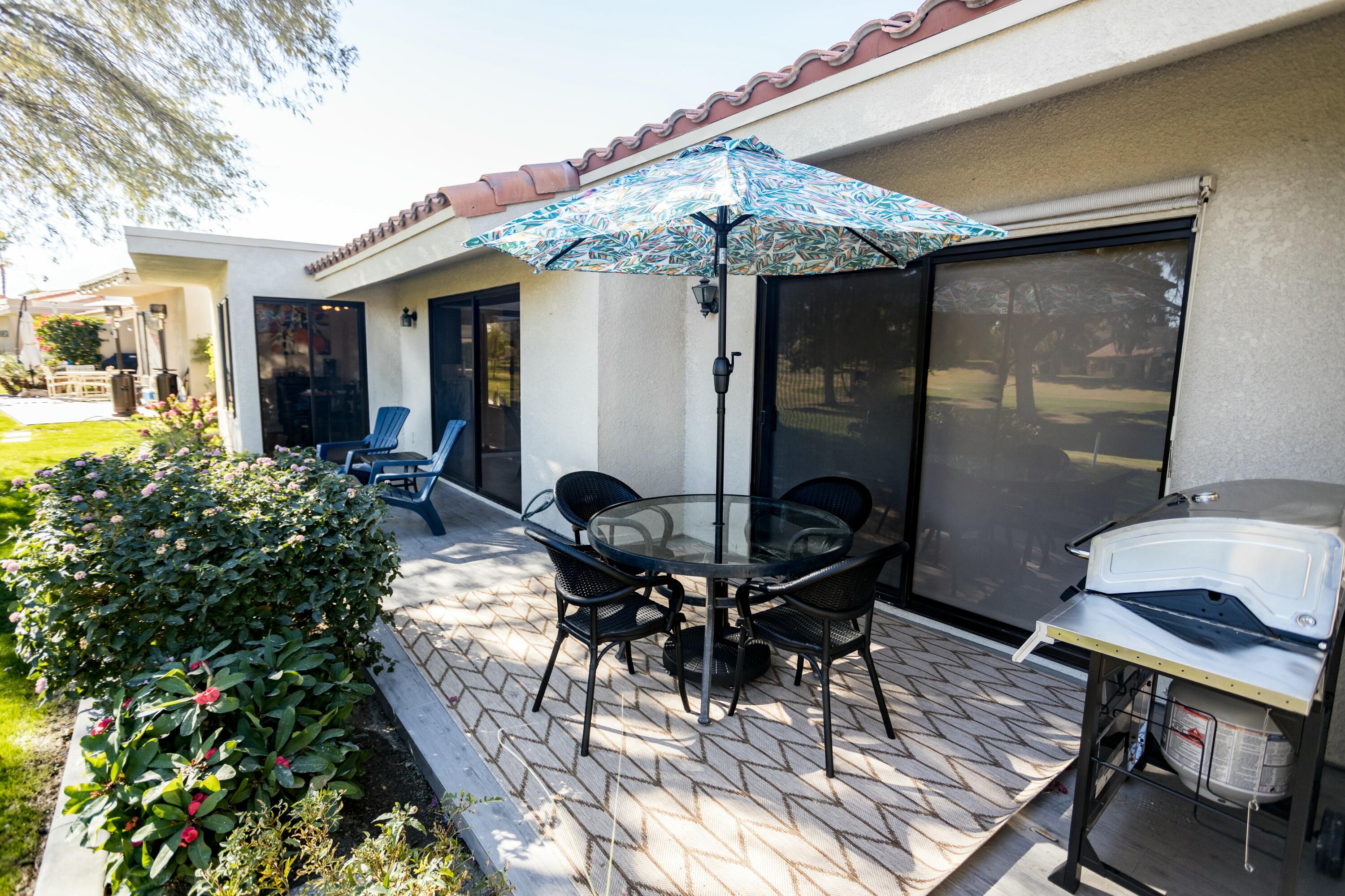 41542 Jupiter Hills Court Palm Desert, CA 92211 - Photo 21 of 29 a patio with glass table and chairs