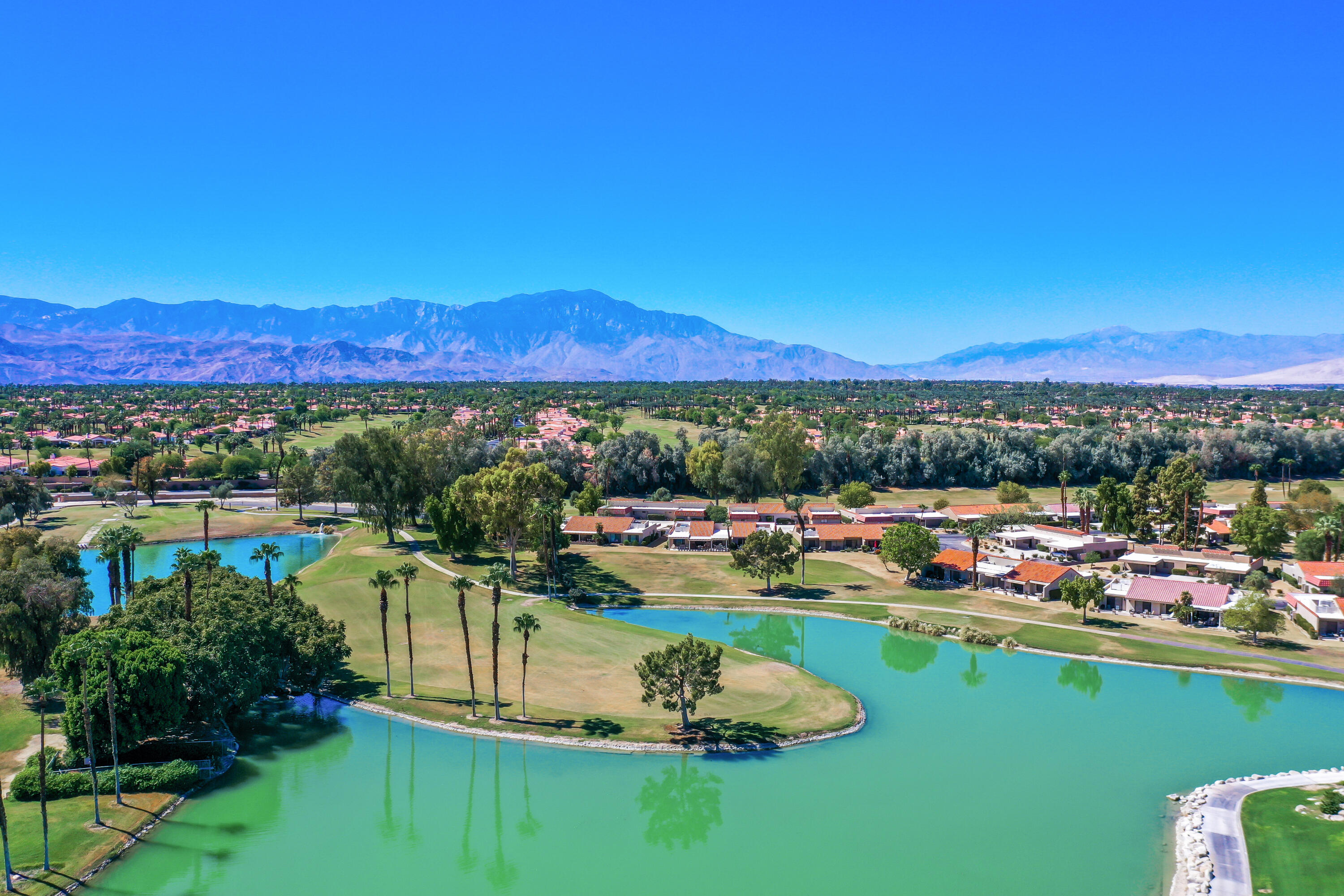 41542 Jupiter Hills Court Palm Desert, CA 92211 - Photo 26 of 29 a view of a lake with a mountain in the background