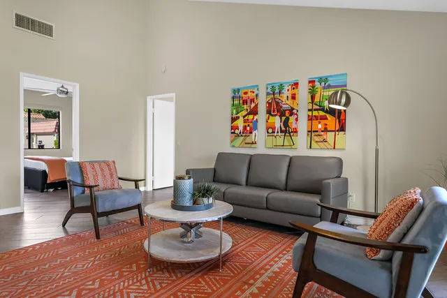 a living room with furniture and wooden floor