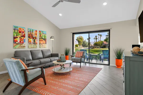 a living room with furniture and a floor to ceiling window