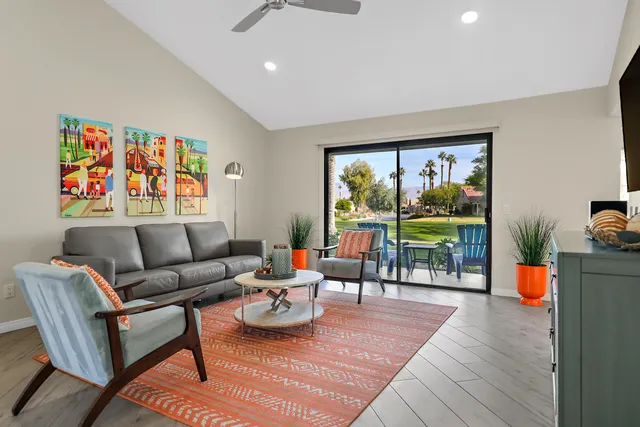 a living room with furniture and a floor to ceiling window