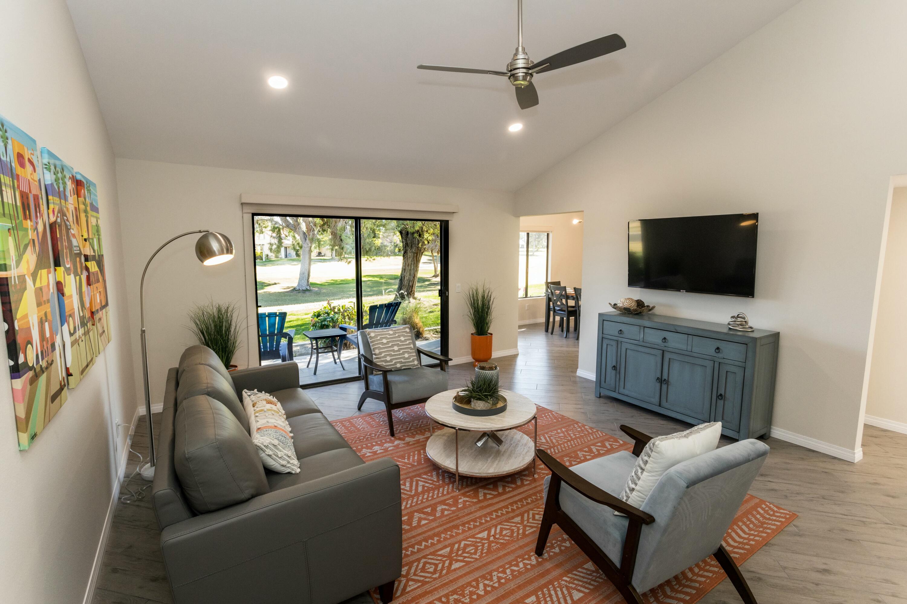41542 Jupiter Hills Court Palm Desert, CA 92211 - Photo 7 of 29 a living room with furniture and a flat screen tv
