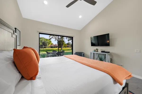 a bedroom with a large bed and a flat screen tv