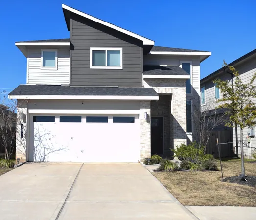 a view of a house with a yard and garage