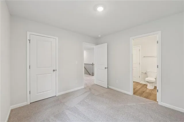 a bathroom with a granite countertop sink a toilet a mirror and bathtub