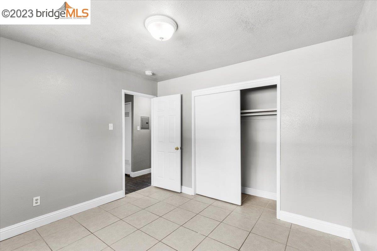 1813 63rd Street, Unit A Berkeley, CA 94703 - Photo 2 of 37 a view of a refrigerator in kitchen and an empty room