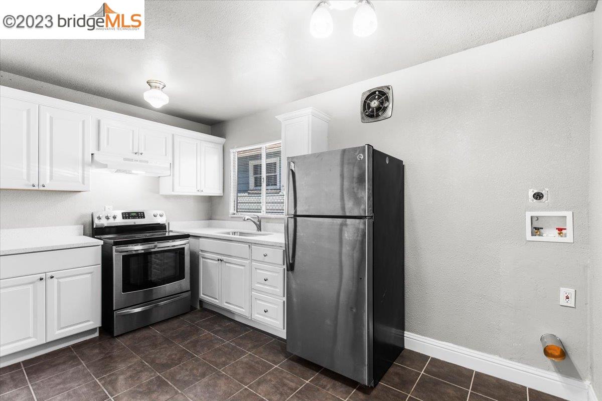 1813 63rd Street, Unit A Berkeley, CA 94703 - Photo 21 of 37 a kitchen with a refrigerator sink and cabinets