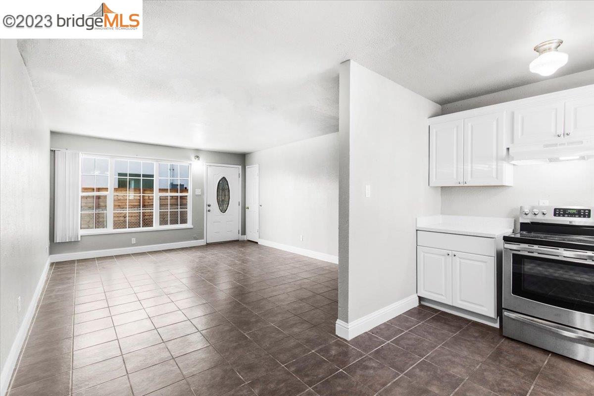 1813 63rd Street, Unit A Berkeley, CA 94703 - Photo 23 of 37 a view of an empty room with a kitchen