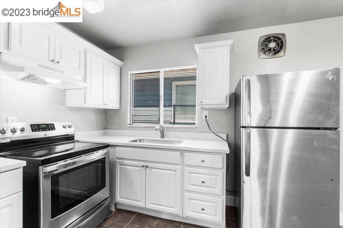 1813 63rd Street, Unit A Berkeley, CA 94703 - Photo 24 of 37 a kitchen with appliances a sink and lots of appliances