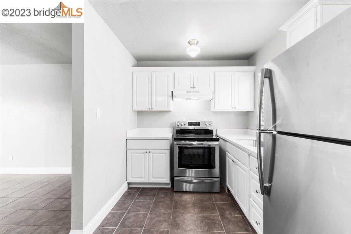 1813 63rd Street, Unit A Berkeley, CA 94703 - Photo 25 of 37 a kitchen with stainless steel appliances a refrigerator and a stove