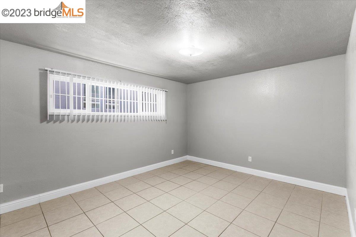 1813 63rd Street, Unit A Berkeley, CA 94703 - Photo 4 of 37 a view of an empty room with a window