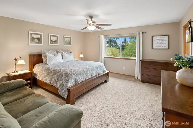 a bedroom with a large bed and a chandelier