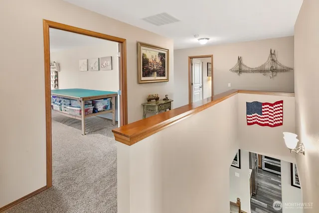 a view of a hallway with paintings on the wall