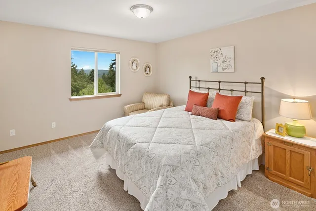 a bedroom with a bed and a night stand